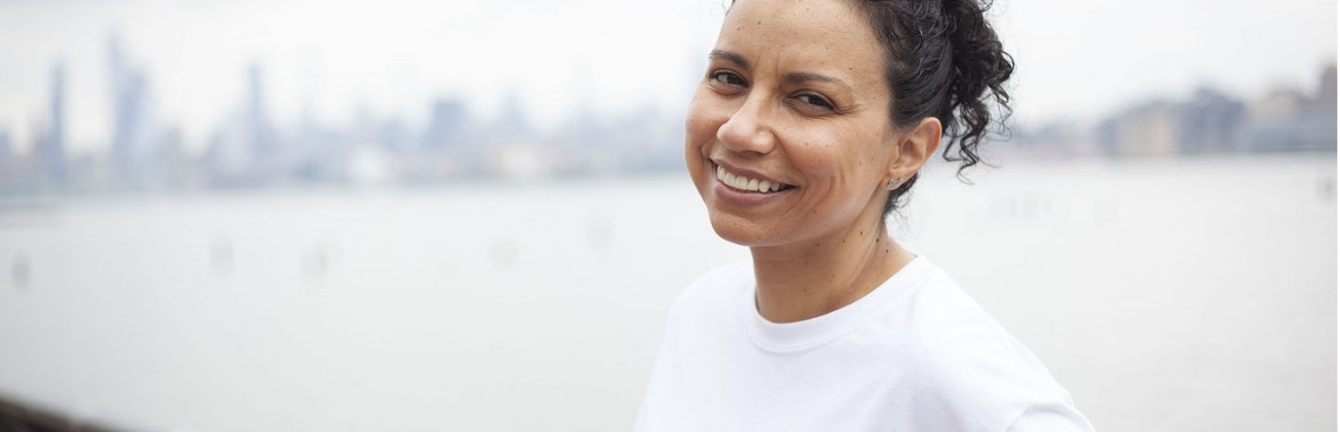 A kidney patient is smiling at the camera.