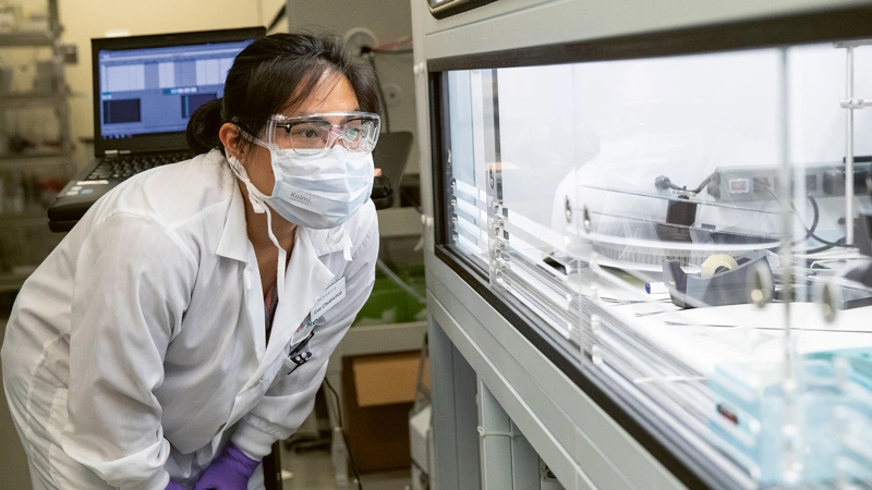 Scientist at mosquito machine