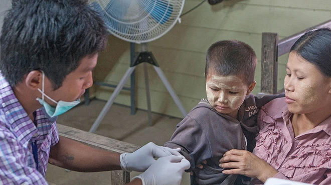 Young child next to his mother getting examine